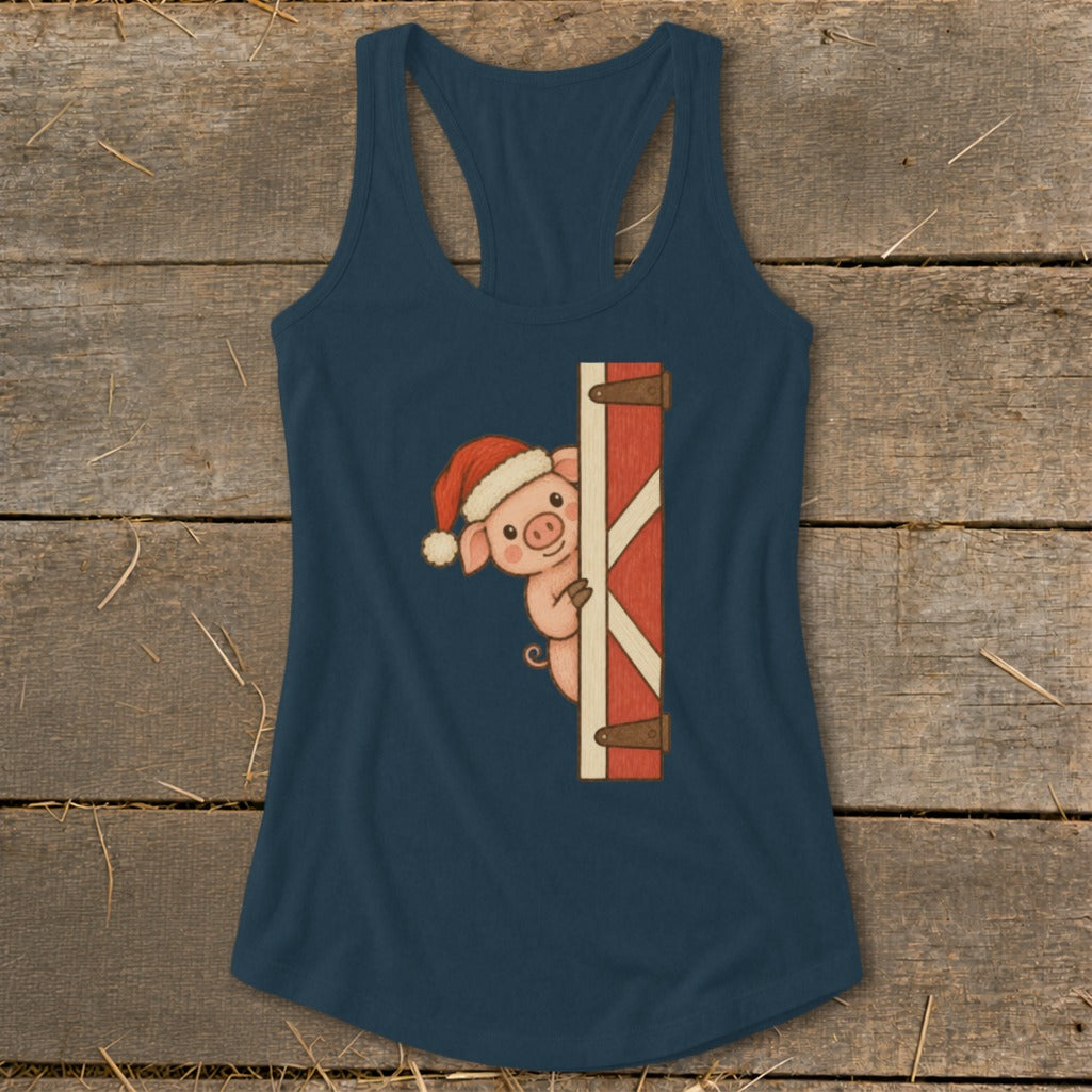 Blue tank top with a cartoon pig wearing a Santa hat peeking around a red barn door.