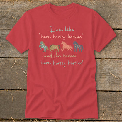 Red t-shirt with text "I was like 'here horsey horsies' and the horsies here horsey horsied" and four horses.