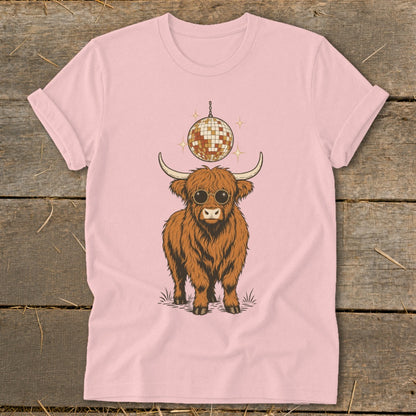 Highland cow wearing sunglasses with disco ball above on pink t-shirt.