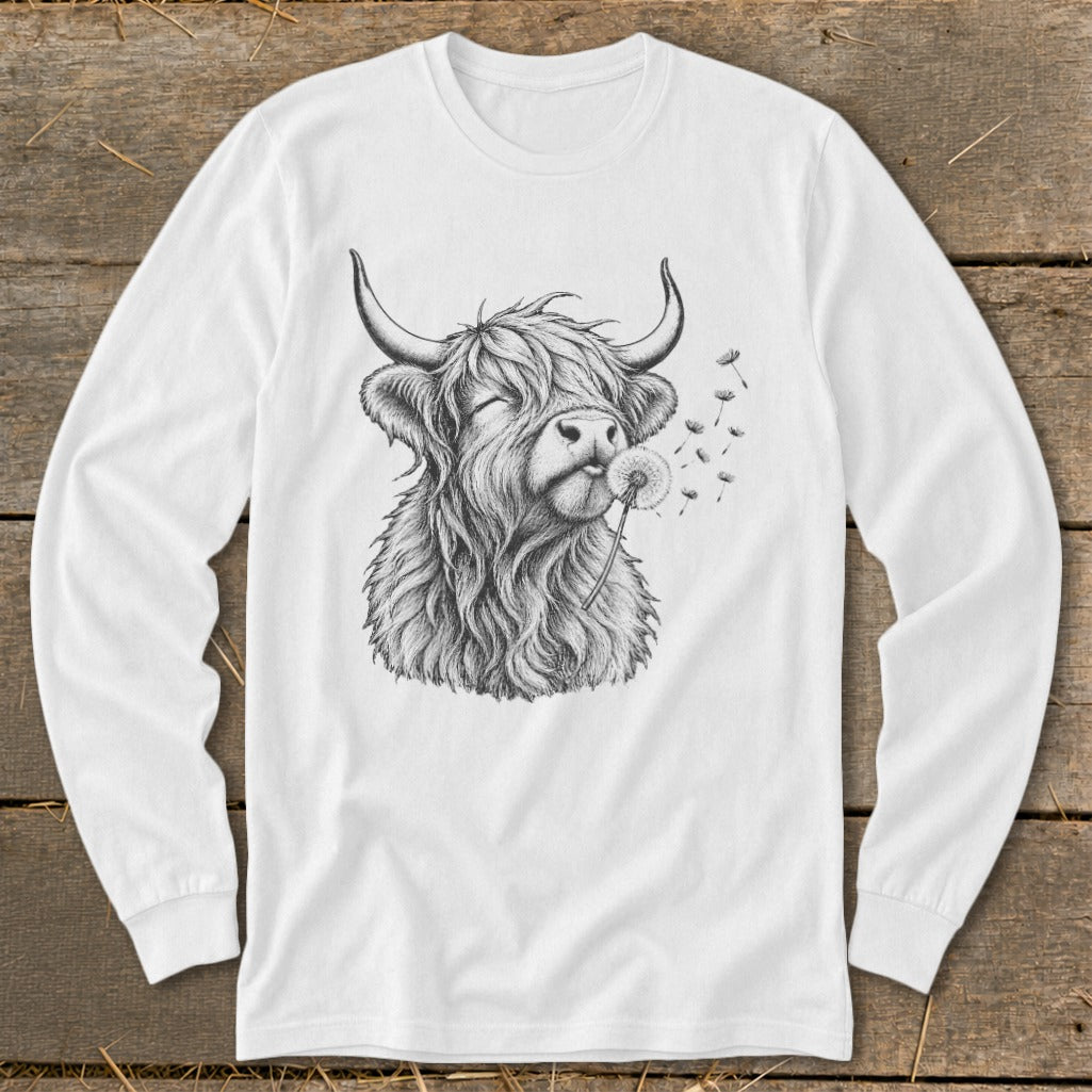 Long sleeve white shirt with a black sketch of a Highland cow blowing a dandelion.