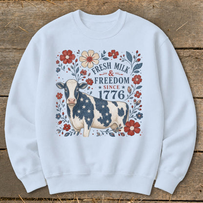 Cow with stars and stripes on a sweatshirt, with text "Fresh Milk & Freedom Since 1776".