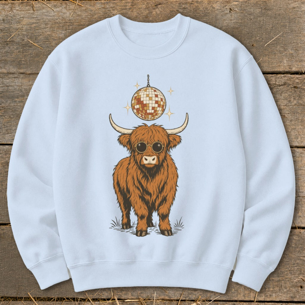 Light blue sweatshirt featuring a cartoon Highland cow wearing sunglasses with a disco ball.