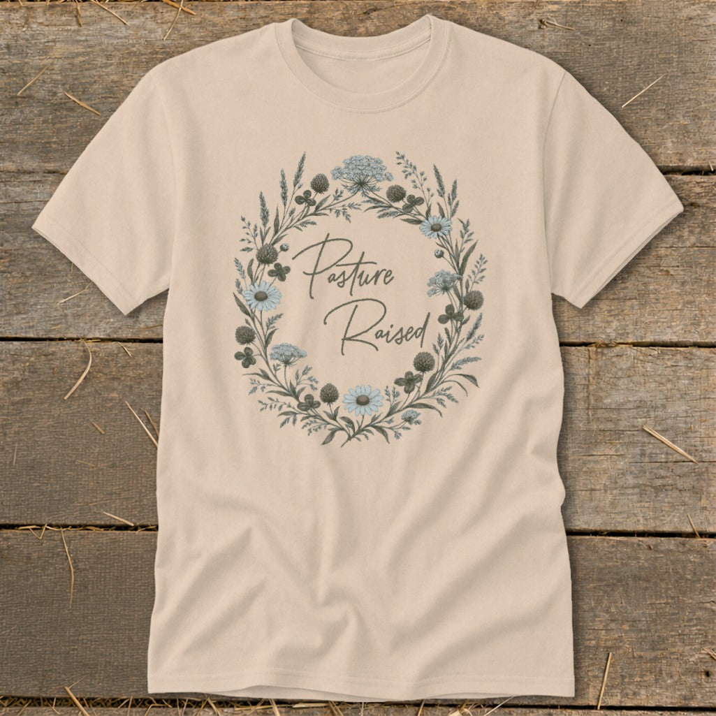 Cream t-shirt with "Pasture Raised" text inside a floral wreath.