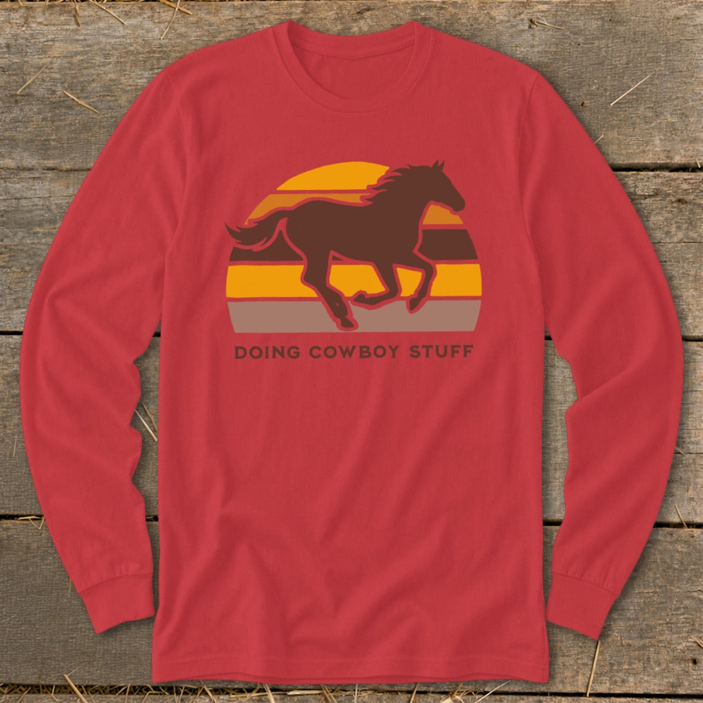 Red long-sleeve shirt with a brown horse silhouette over a sunset graphic and text.