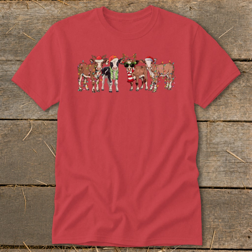 Red t-shirt with cartoon cows wearing Santa hats and Christmas lights.