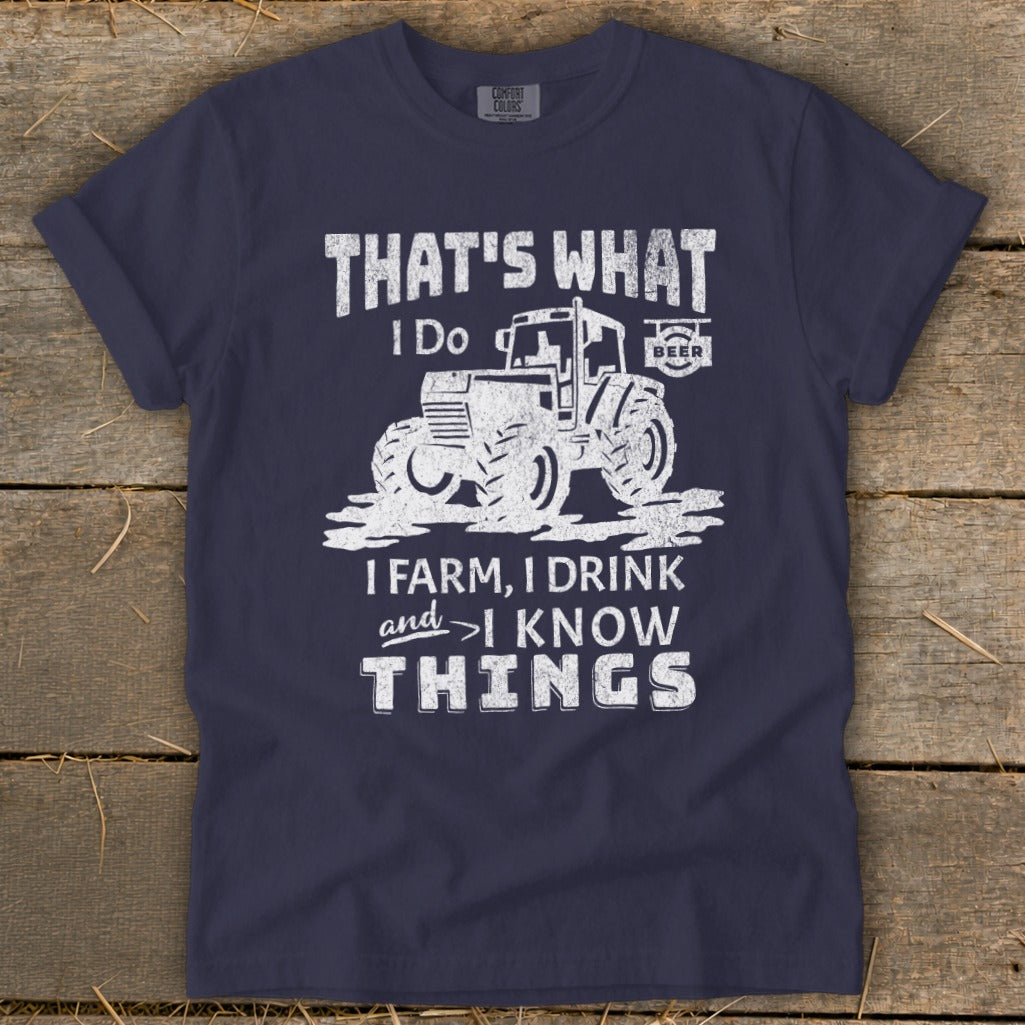 Navy t-shirt with distressed graphic of tractor and text "That's what I do. I farm, I drink, and I know things."