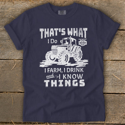 Navy t-shirt with distressed graphic of tractor and text "That's what I do. I farm, I drink, and I know things."