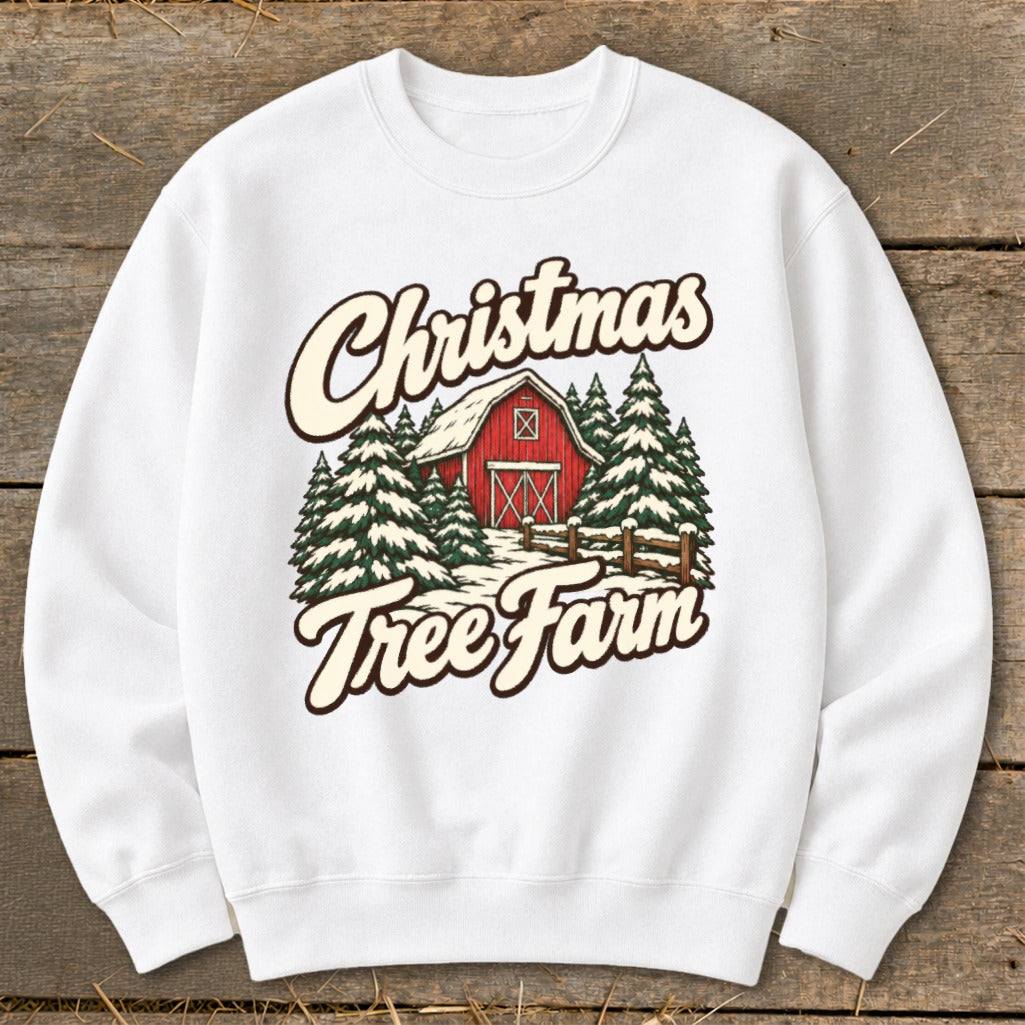 White sweatshirt with "Christmas Tree Farm" graphic featuring a red barn and snowy trees.