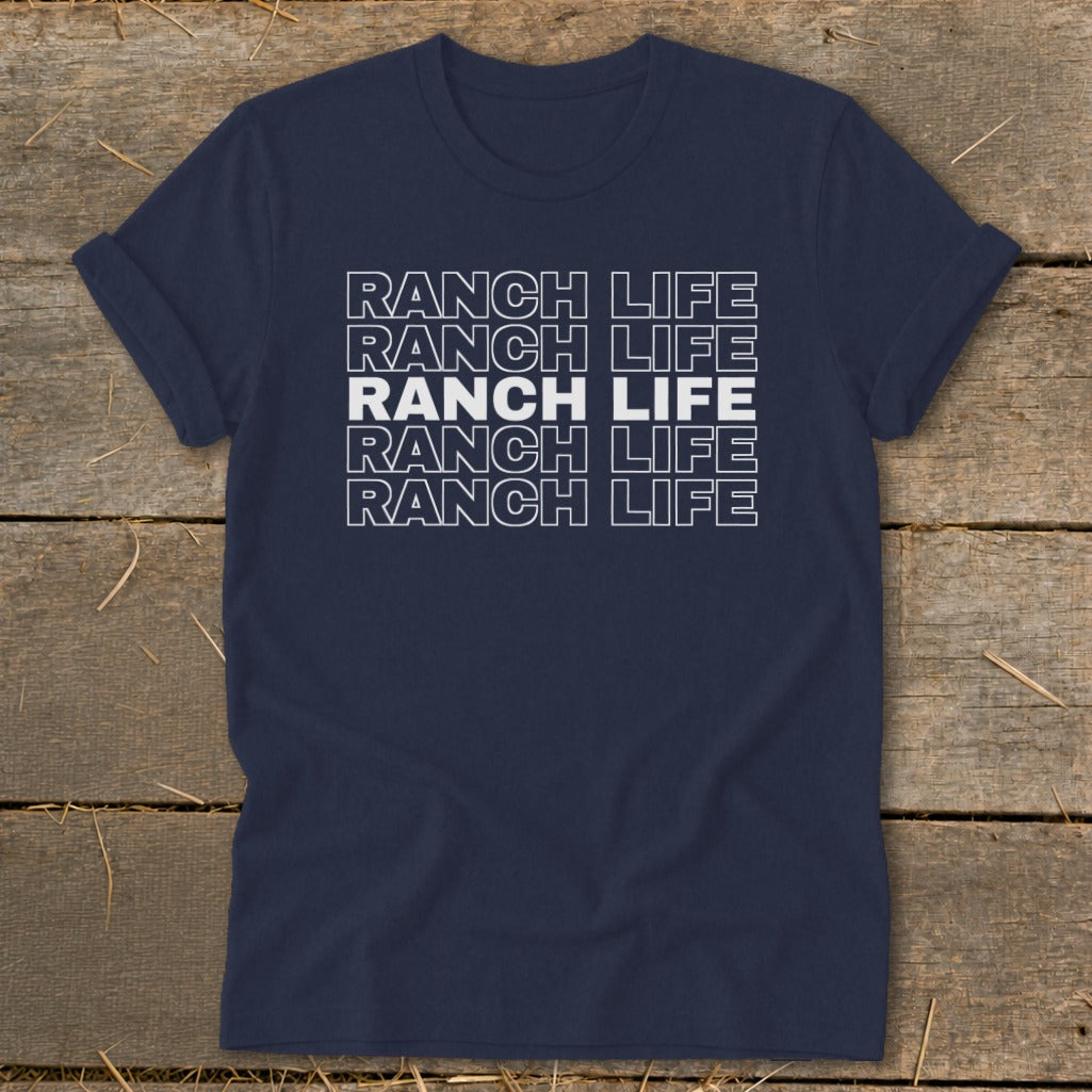 Dark blue t-shirt featuring repeated white text spelling RANCH LIFE on a wooden background.