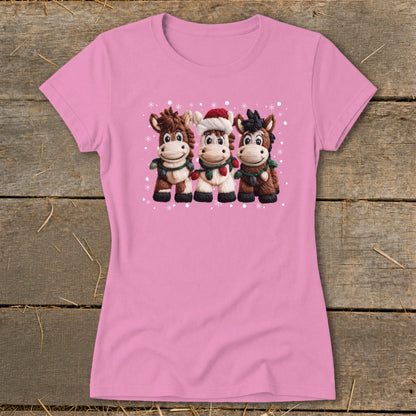 Pink t-shirt with three cartoon horses wearing scarves and one with a Santa hat.