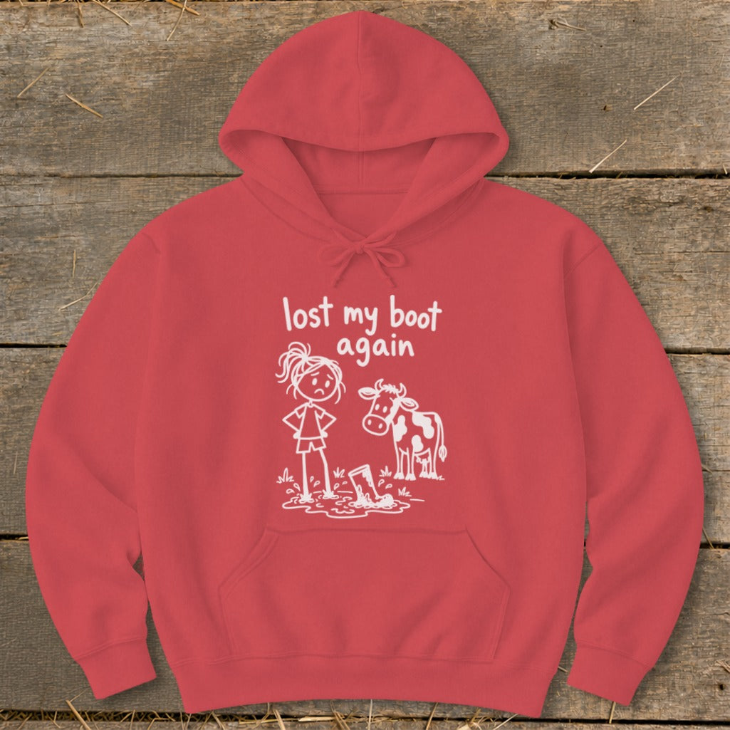 Red hooded sweatshirt with white graphic of a stick figure and cow next to a mud puddle, featuring the text lost my boot again