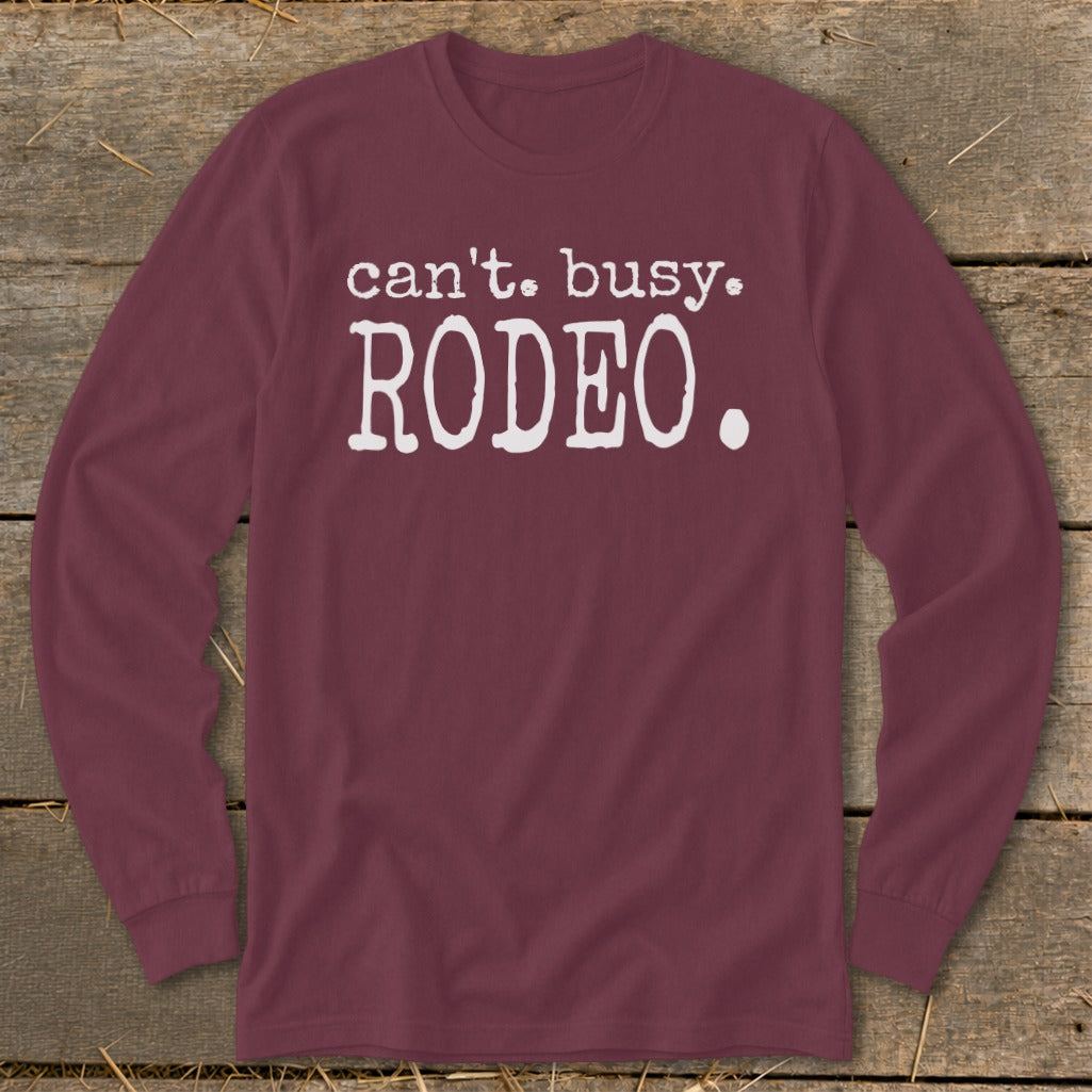 Maroon long-sleeve shirt with white text reading "can't. busy. RODEO.".