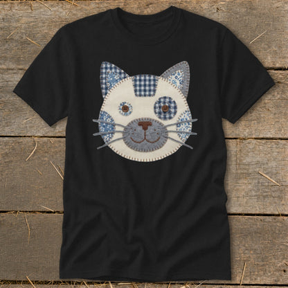 Black t-shirt with a stitched patchwork cat face applique in blue and white patterns.