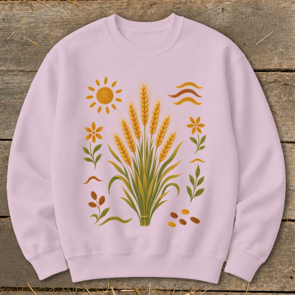 Light pink sweatshirt with a graphic of wheat stalks, sun, flowers, leaves, and seeds.