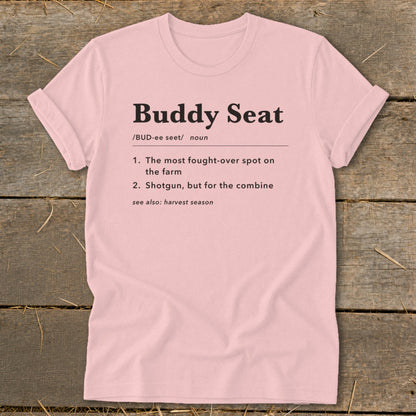 Pink t-shirt with "Buddy Seat" definition: "The most fought-over spot on the farm."