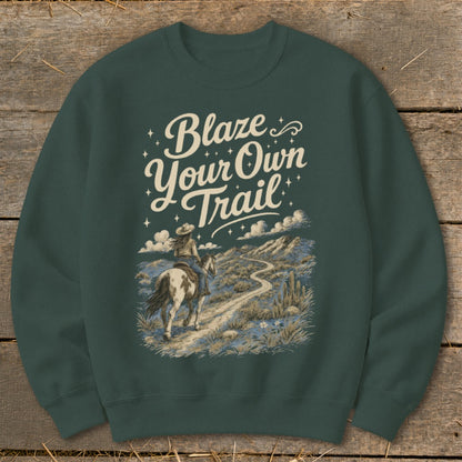Dark green sweatshirt with "Blaze Your Own Trail" text and equestrian desert scene graphic.