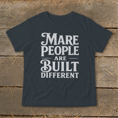 Dark gray t-shirt with white text "Mare People Are Built Different".