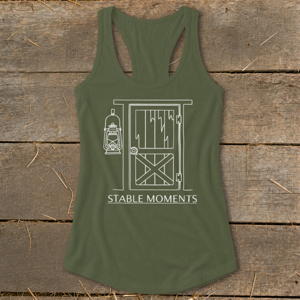 Olive green tank top with white line drawing of a stable door and lantern, reads "STABLE MOMENTS."