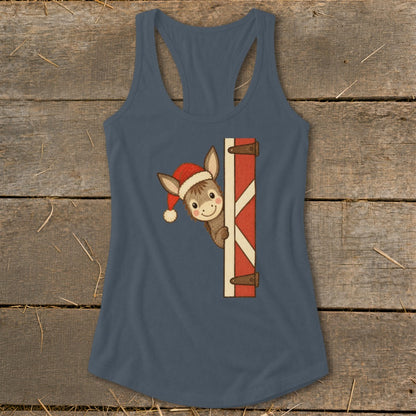 Donkey wearing Santa hat peeking from barn door graphic on a blue tank top.