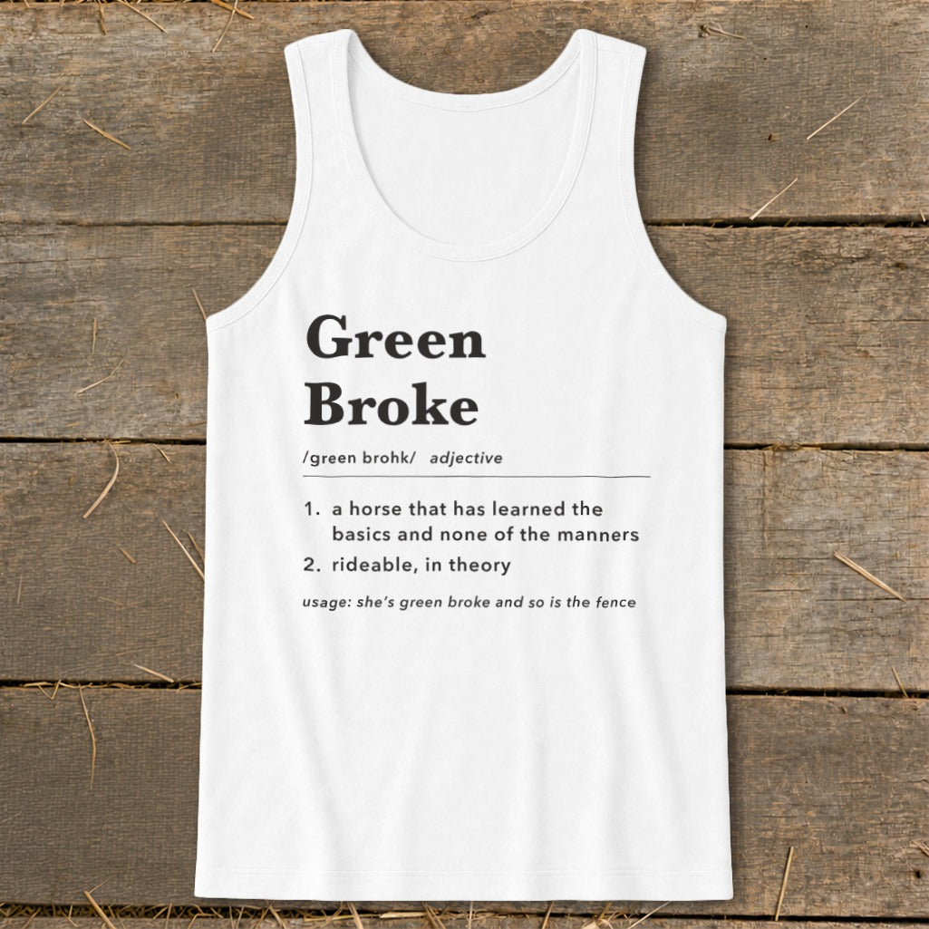 White tank top featuring black dictionary-style text defining the term green broke centered on a wooden background.
