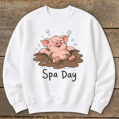 White sweatshirt with cartoon pig in mud labeled "Spa Day".
