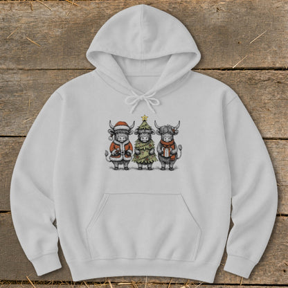 White hoodie with a Christmas-themed drawing of three Highland cows.