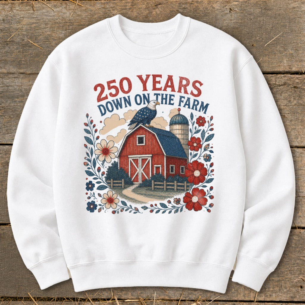 White sweatshirt with a barn, eagle, silo, flowers, and text "250 YEARS DOWN ON THE FARM".