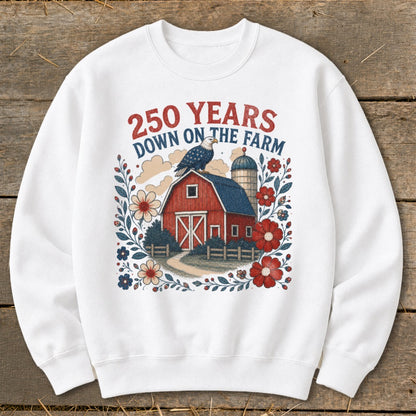 White sweatshirt with a barn, eagle, silo, flowers, and text "250 YEARS DOWN ON THE FARM".
