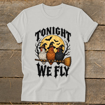 Three witches' hats wearing chickens sit on a broomstick with text "Tonight We Fly."