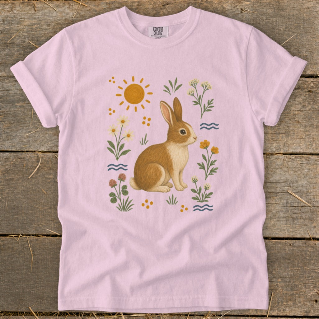 Pink t-shirt with a cute bunny surrounded by flowers and sun.