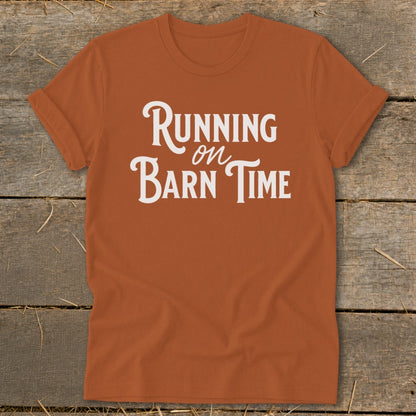 Orange t-shirt with white text reading "Running on Barn Time".