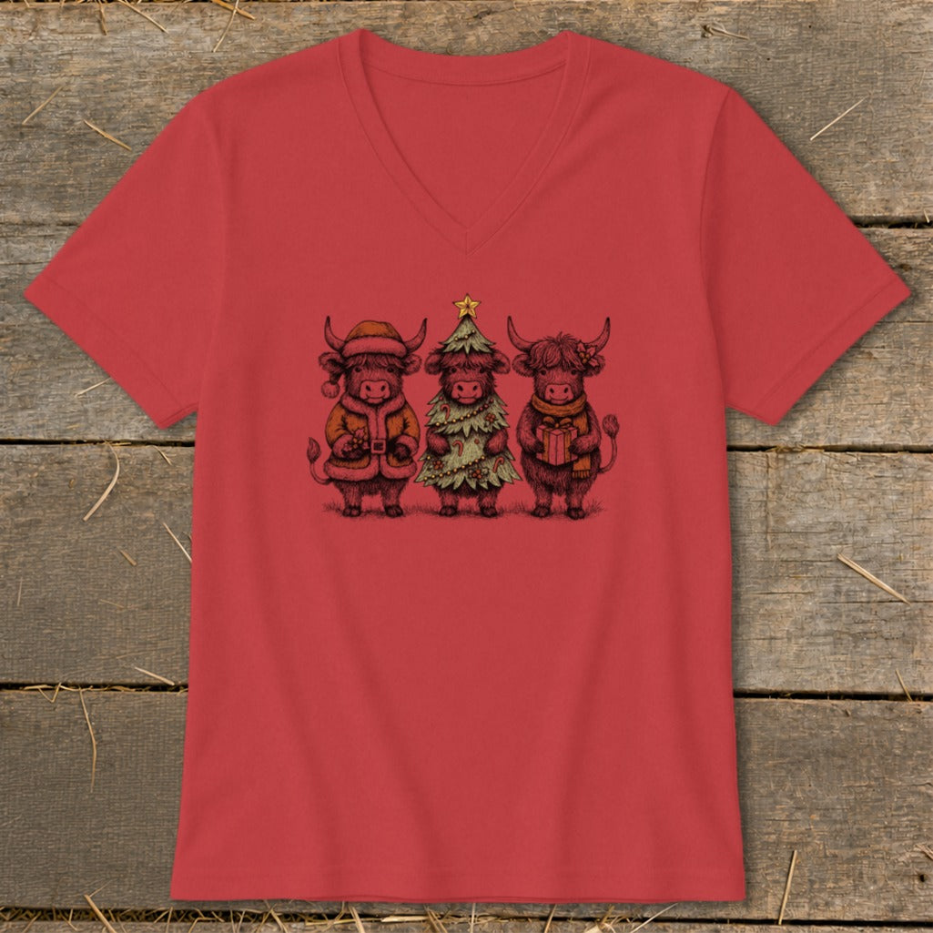 Three Highland cows dressed for Christmas on a red v-neck shirt.