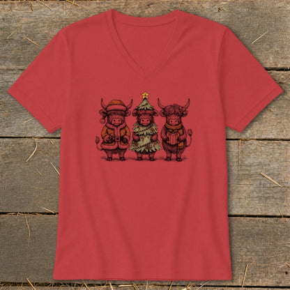Three Highland cows dressed for Christmas on a red v-neck shirt.