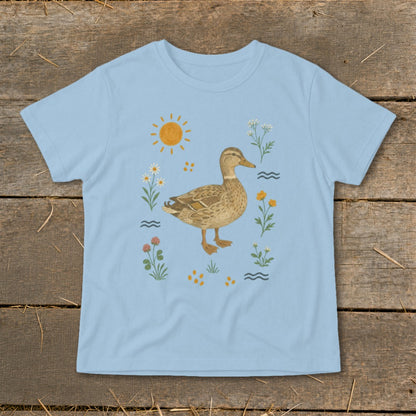 Light blue t-shirt with a duck surrounded by flowers, sun, and waves.