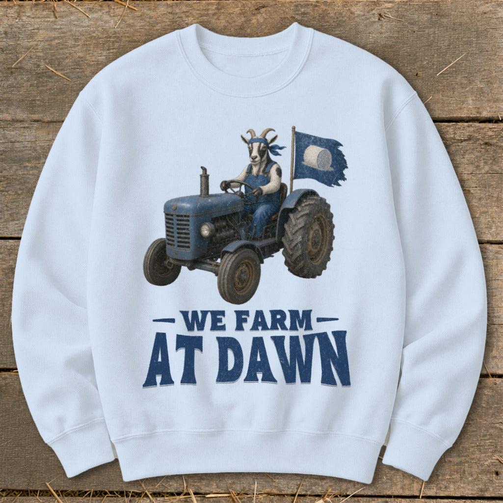 Light blue sweatshirt with goat driving tractor, "We Farm At Dawn" text.