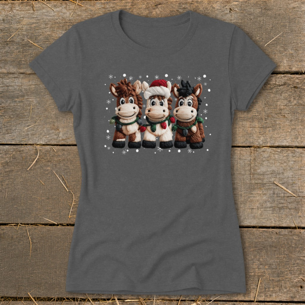 Three cartoon horses wearing Santa hats and Christmas lights with snowflakes.