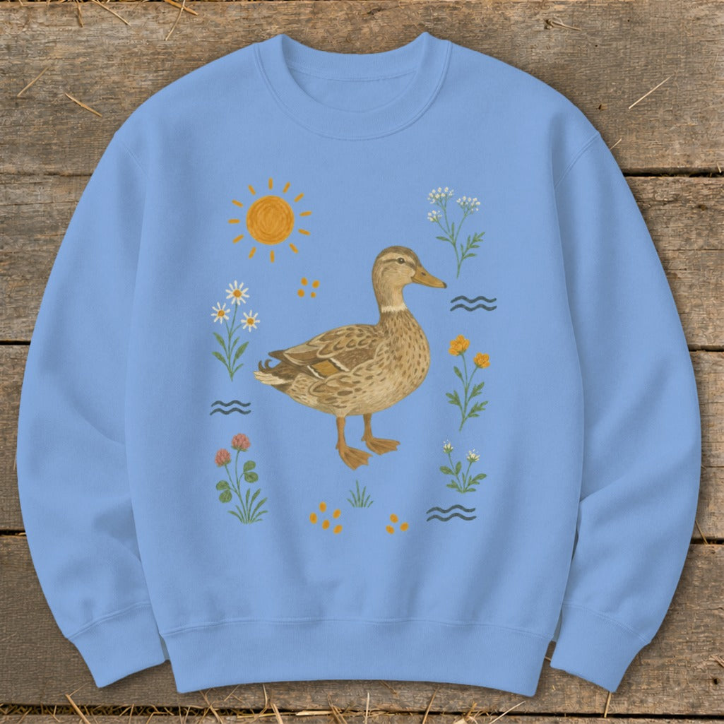 Light blue sweatshirt with a duck and floral illustrations.