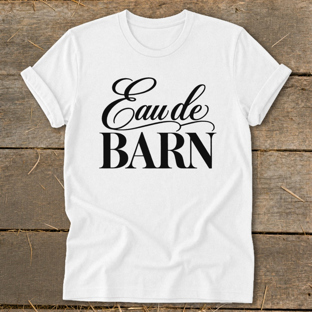 White t-shirt with "Eau de BARN" text in black script font.