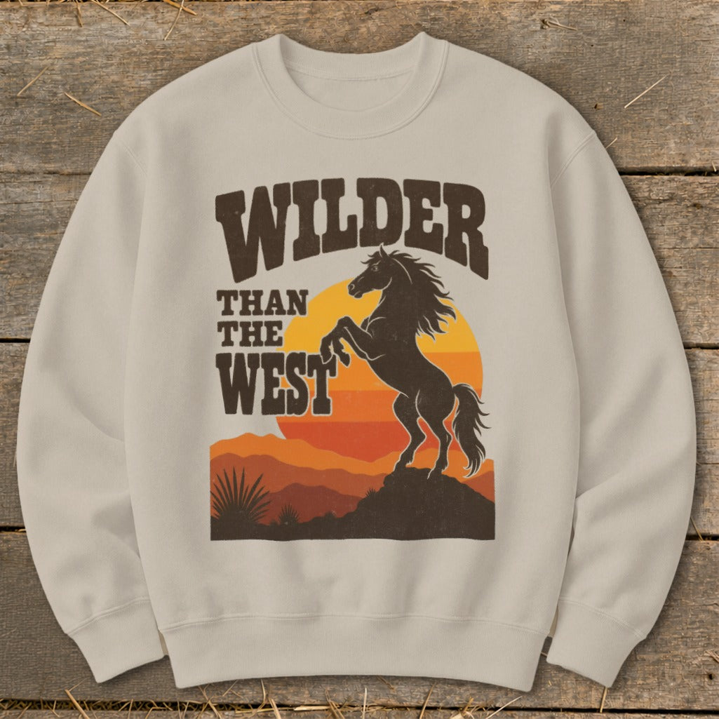 Crewneck sweatshirt with "Wilder Than The West" graphic featuring a rearing horse at sunset.
