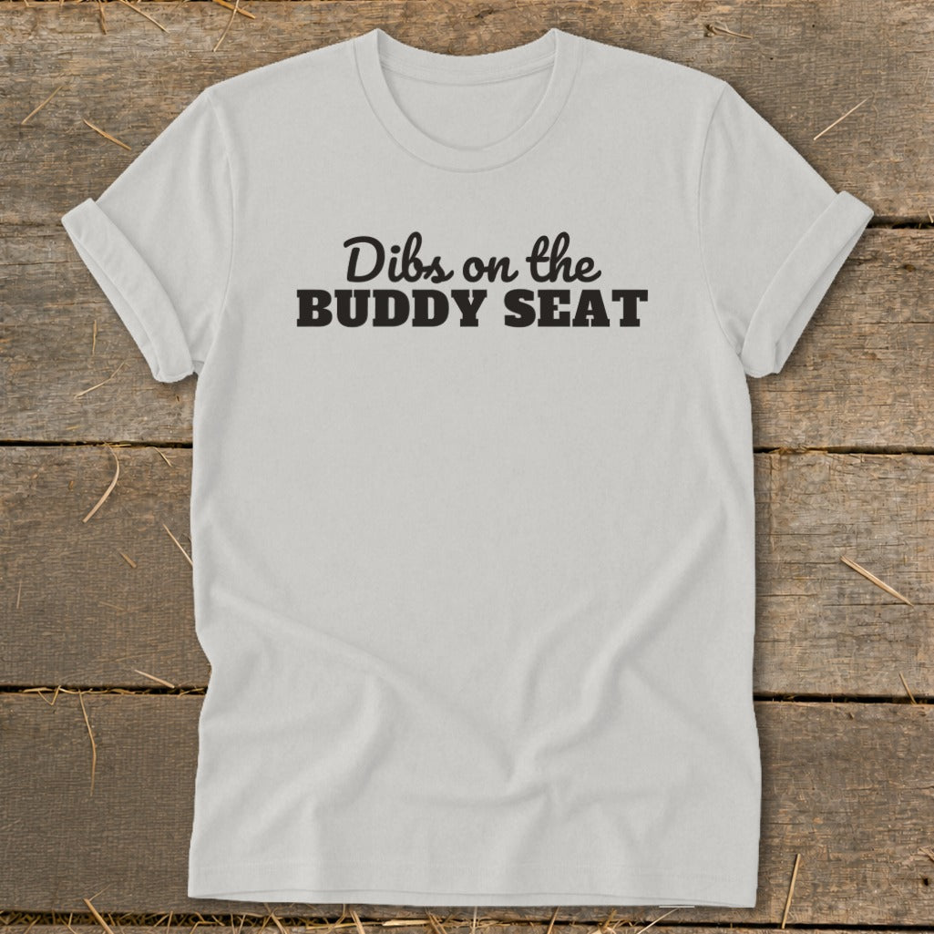 White t-shirt with black text "Dibs on the BUDDY SEAT".