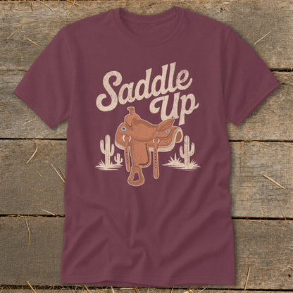 Maroon t-shirt with a cowboy saddle and cactus graphic that says "Saddle Up".
