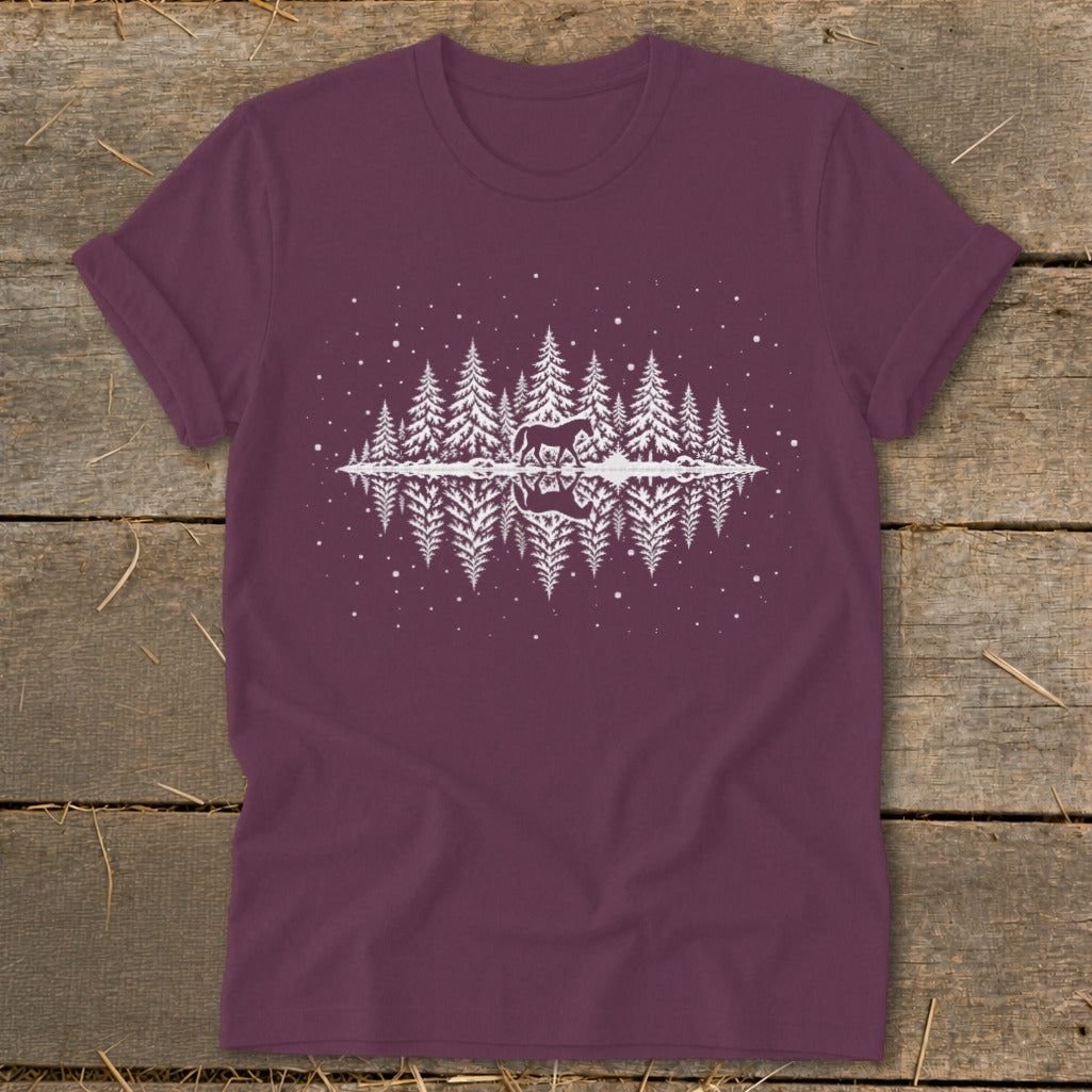 Maroon t-shirt with white graphic of horse in snowy pine forest reflected in water.