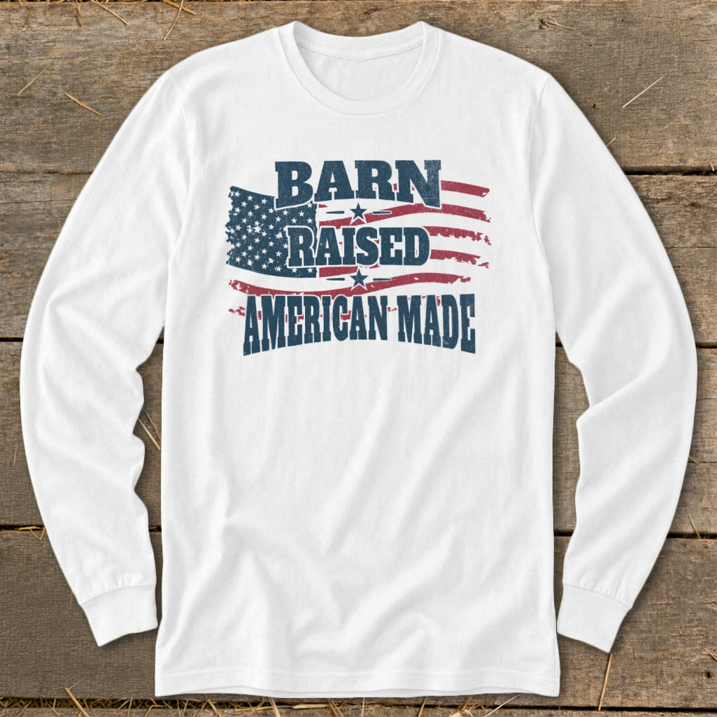 White long sleeve shirt with distressed American flag and text "BARN RAISED AMERICAN MADE".