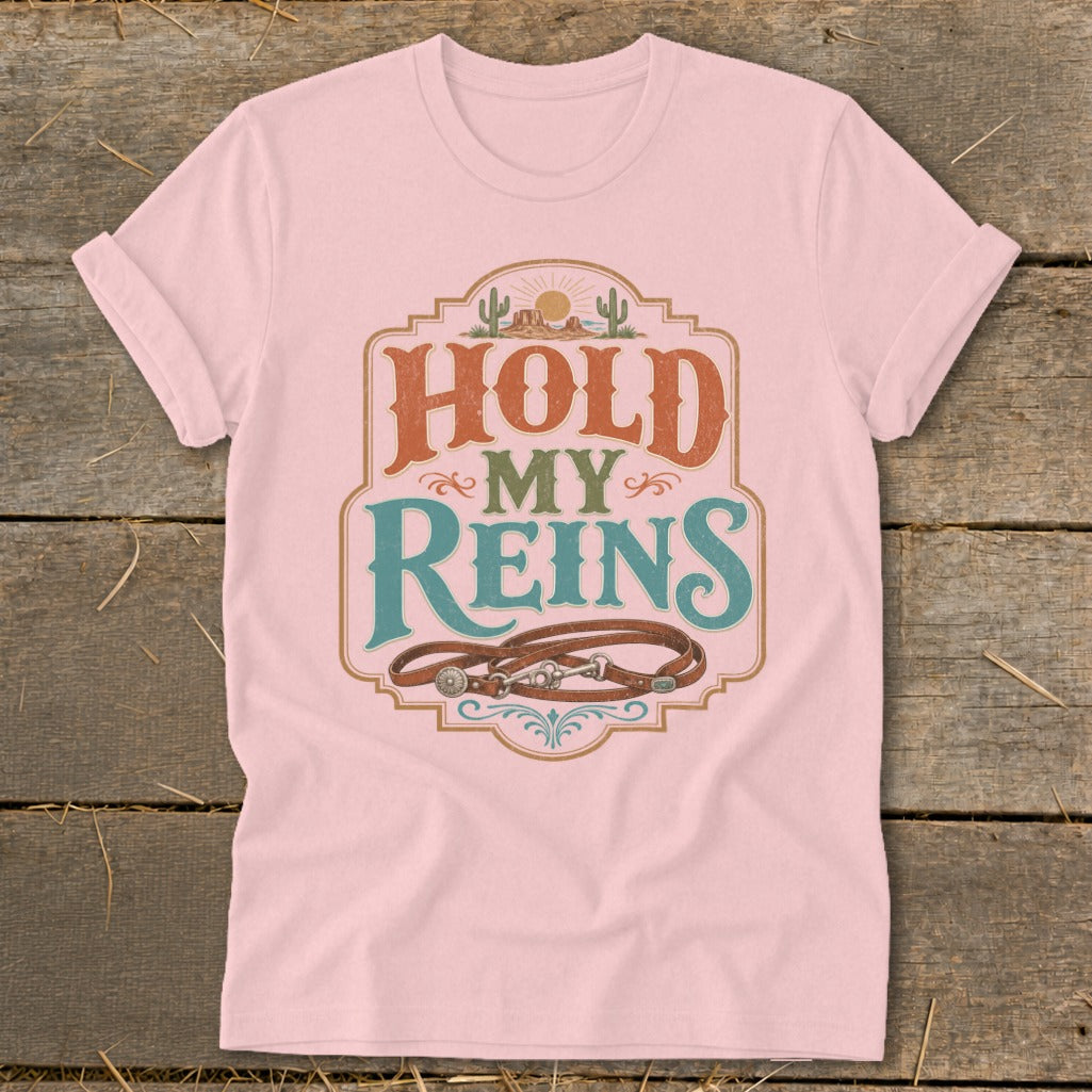 Pink t-shirt with "Hold My Reins" text and a leather horse bridle design.
