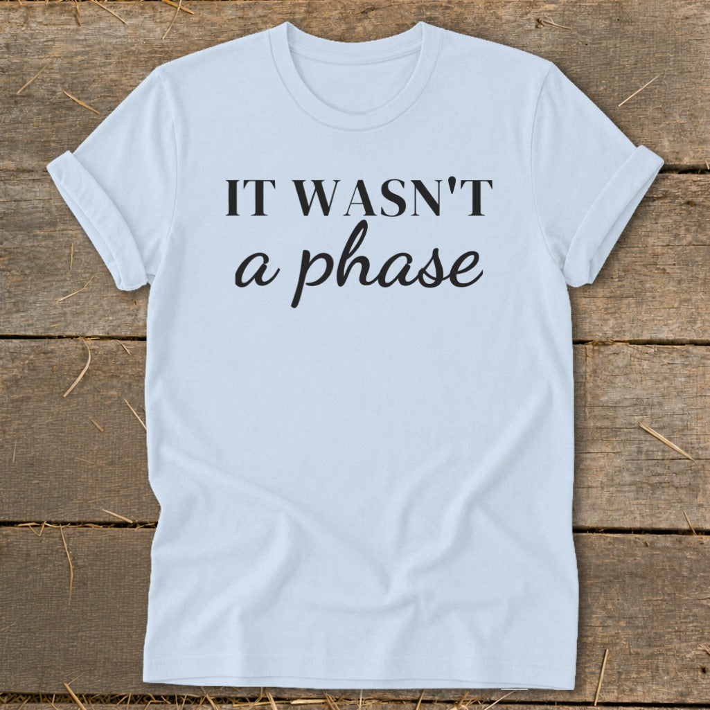 Light blue t-shirt with black text reading "IT WASN'T a phase".