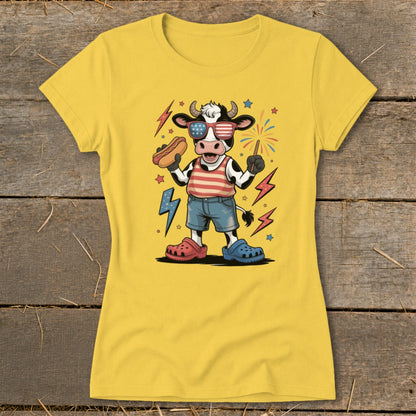 Cartoon cow wearing American flag sunglasses, holding a hot dog and sparkler.