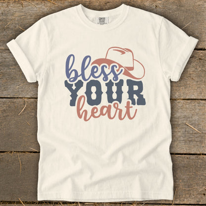 White t-shirt with "bless YOUR heart" text and a cowboy hat graphic.