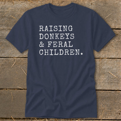 Navy t-shirt with white text reading "RAISING DONKEYS & FERAL CHILDREN."