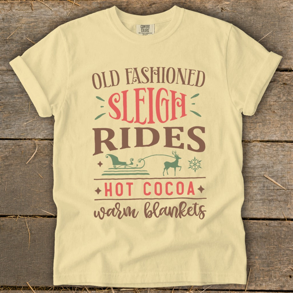 Cream t-shirt with "Old Fashioned Sleigh Rides Hot Cocoa Warm Blankets" text and graphics.