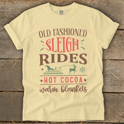 Cream t-shirt with "Old Fashioned Sleigh Rides Hot Cocoa Warm Blankets" text and graphics.